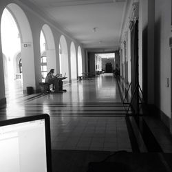 Empty corridor along pillars