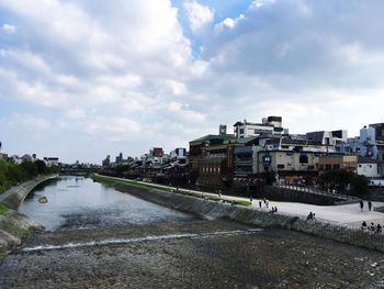 Buildings against cloudy sky