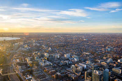 Aerial view of cityscape against sky during sunset