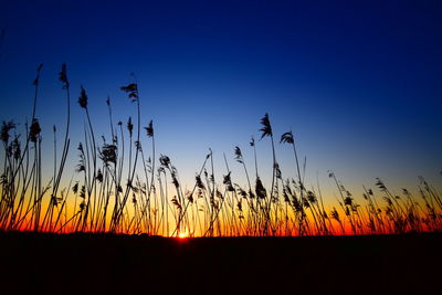 Silhouette landscape against clear sky during sunset