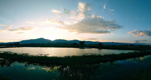 Scenic view of lake against sky during sunset