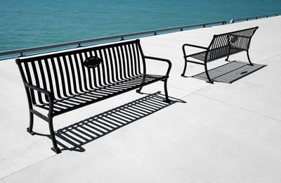 High angle view of empty chairs by swimming pool