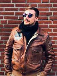 Portrait of young man wearing sunglasses standing outdoors