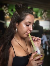 Close-up of woman drinking glass