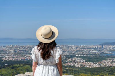 Rear view of woman standing on hill at klis fortress above city of split in croatia