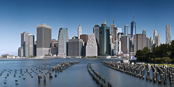 Modern buildings by river at manhattan in city