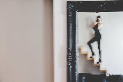 Young woman standing at home