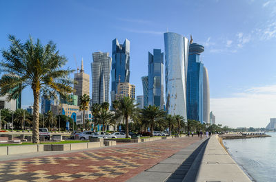 Skyscrapers in city against blue sky