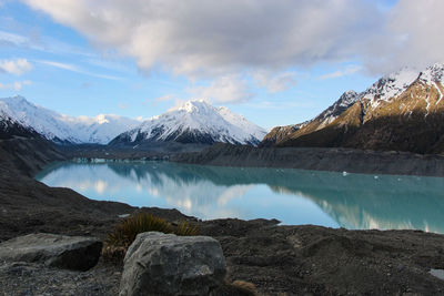 Scenic view of lake and mountains against sky