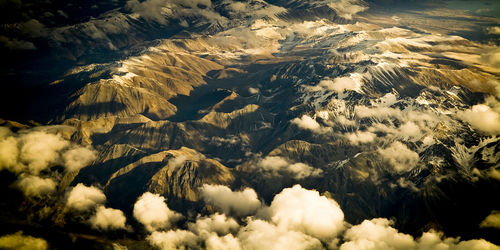 Aerial view of snowcapped mountains against sky