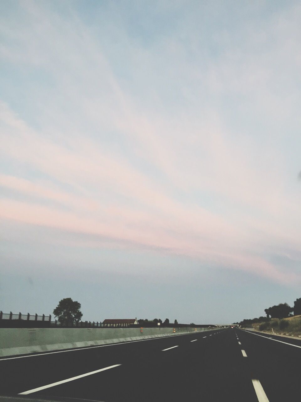 transportation, road, sky, the way forward, road marking, cloud - sky, vanishing point, diminishing perspective, nature, street, tree, cloudy, tranquility, outdoors, tranquil scene, cloud, no people, landscape, beauty in nature, scenics