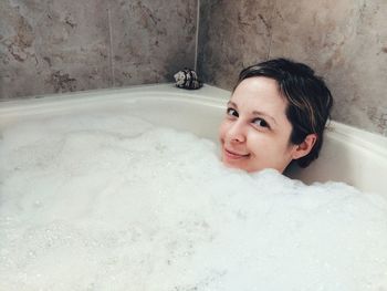 Portrait of smiling young woman in bathroom