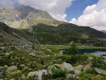 Scenic view of lake and mountains against sky