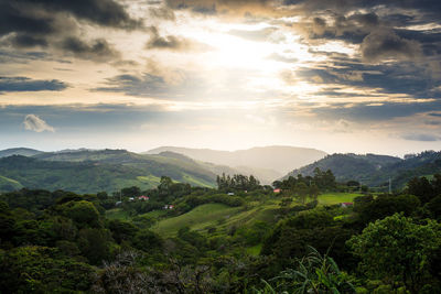 Scenic view of mountains against cloudy sky