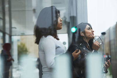 Female friends at bus stop