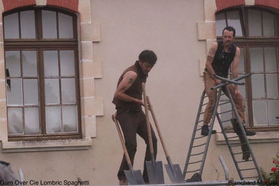 Side view of man standing against window in building