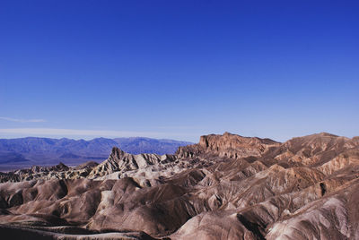 Scenic view of dramatic landscape against clear blue sky