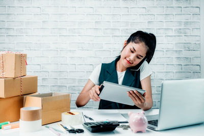 Mid adult woman using mobile phone