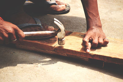 Low section of man working on floor