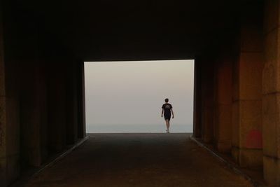 Rear view of woman walking in corridor