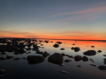 Scenic view of sea against sky at sunset