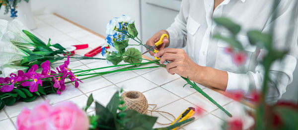 Midsection of woman holding christmas decoration