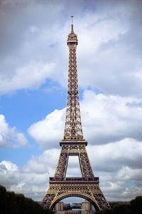 Low angle view of eiffel tower against cloudy sky