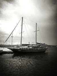 Boats sailing in river against sky