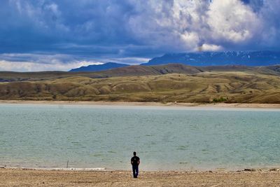 Woman on beach against sky