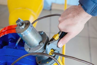 Low section of man repairing car