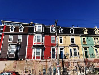 Low angle view of buildings in newfoundland against clear blue sky