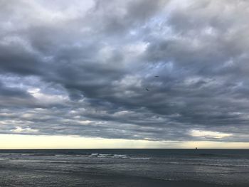 Scenic view of sea against dramatic sky