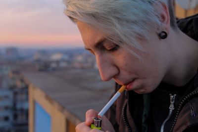 Close-up of woman smoking on rooftop