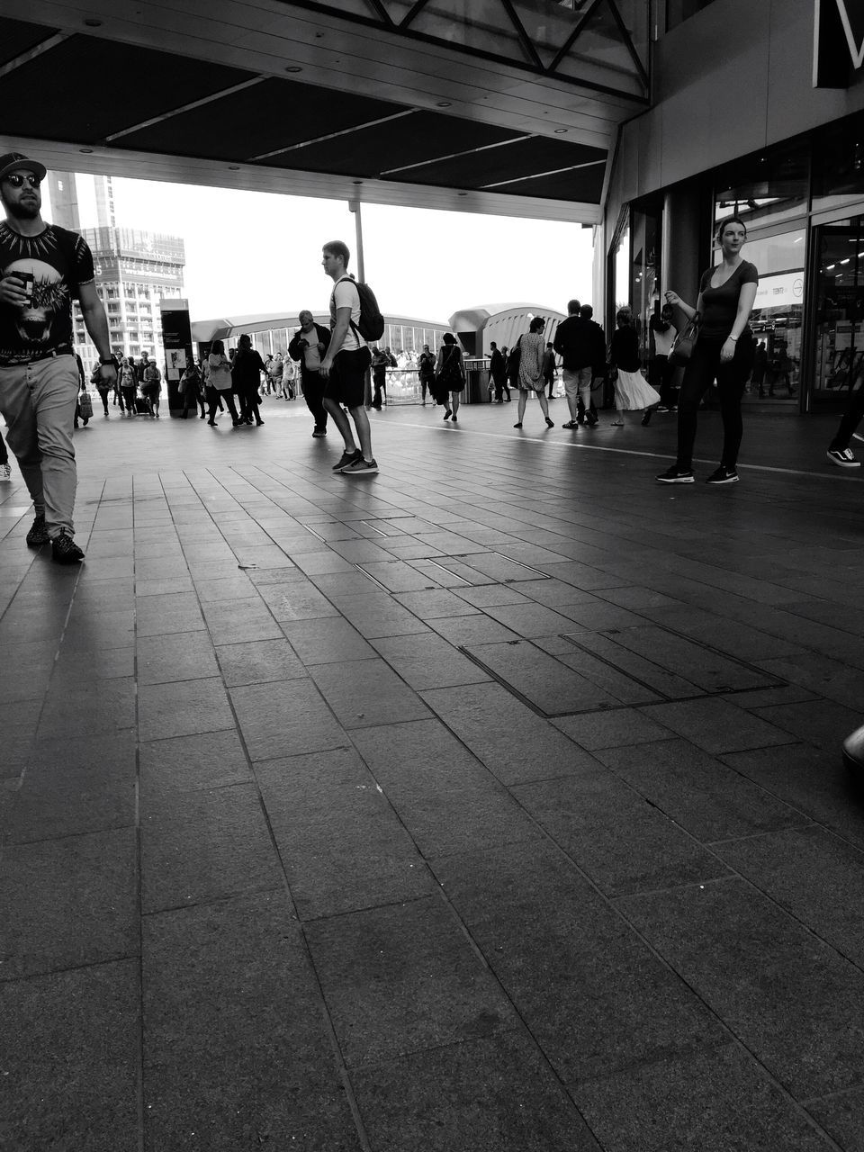 PEOPLE WALKING ON RAILROAD STATION PLATFORM