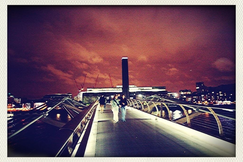 transfer print, transportation, auto post production filter, sky, architecture, the way forward, built structure, diminishing perspective, land vehicle, mode of transport, road, cloud - sky, railing, illuminated, connection, vanishing point, car, road marking, bridge - man made structure, no people