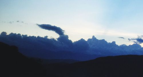 Scenic view of silhouette mountains against sky