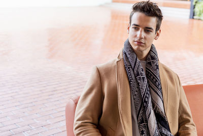 Portrait of young man standing in city