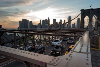 Vehicles moving under brooklyn bridge road over east river