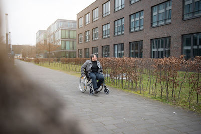 A physically disabled person on a wheelchair at a walk