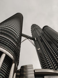 Low angle view of patronas towers against sky