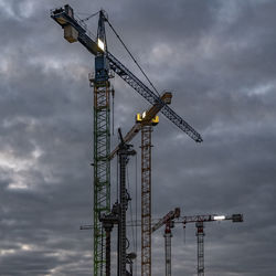 Crane against cloudy sky