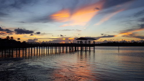 Scenic view of sea against dramatic sky during sunset