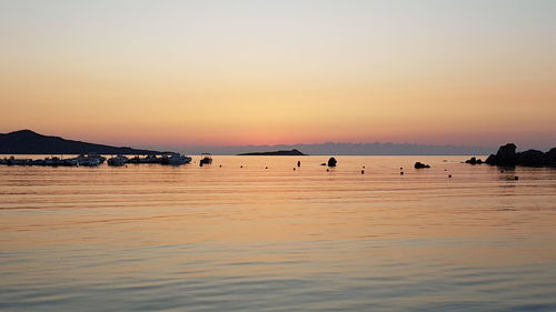 Scenic view of sea against clear sky during sunset