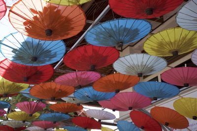 Multi colored umbrellas hanging at market