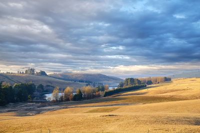 Scenic view of landscape against cloudy sky