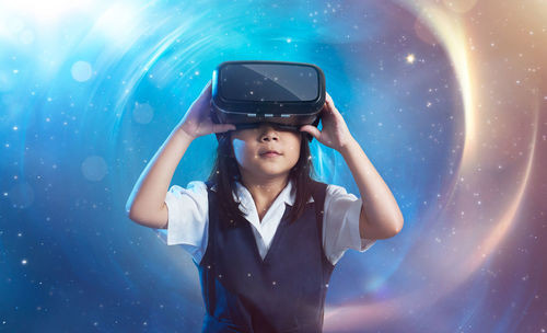 Close-up of boy wearing sunglasses against sky at night