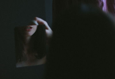 Close-up of woman holding mirror