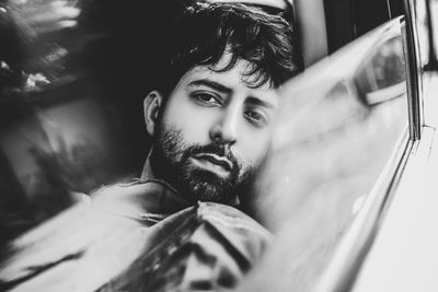 Portrait of young man in car