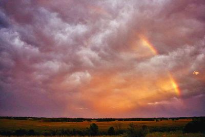 Scenic view of dramatic sky over landscape during sunset