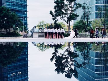 Group of people by swimming pool in city